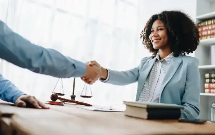 woman shaking hands with a security clearance lawyer