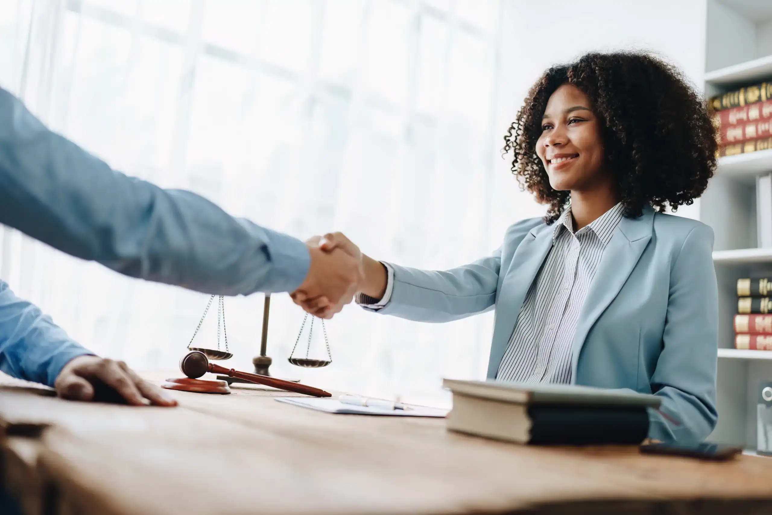 woman shaking hands with a security clearance lawyer