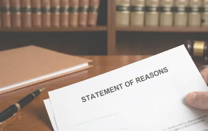 Lawyer holding Statement of Reasons document